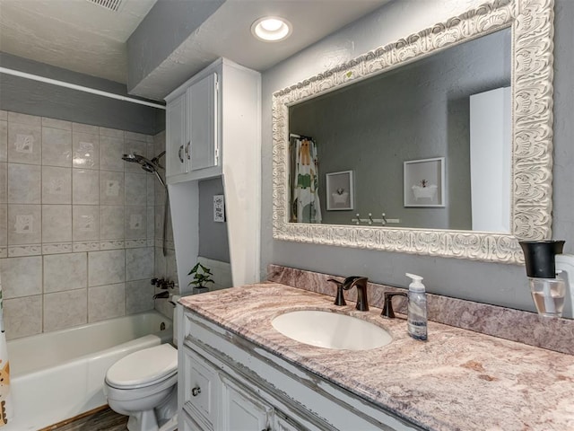 full bathroom featuring vanity, shower / bath combo, and toilet