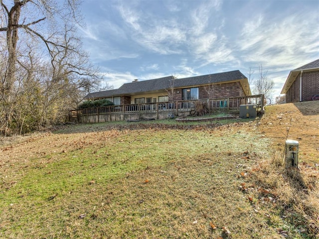 rear view of house featuring a lawn