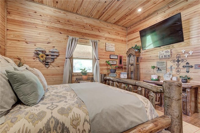 bedroom with wood ceiling, wood walls, and light hardwood / wood-style floors