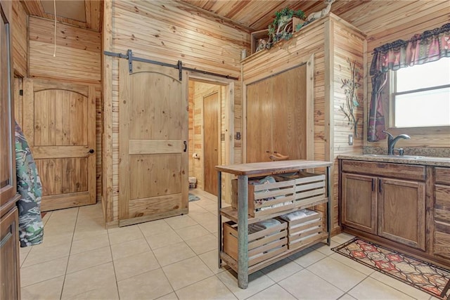 bathroom featuring tile patterned floors, wooden walls, vanity, and wooden ceiling