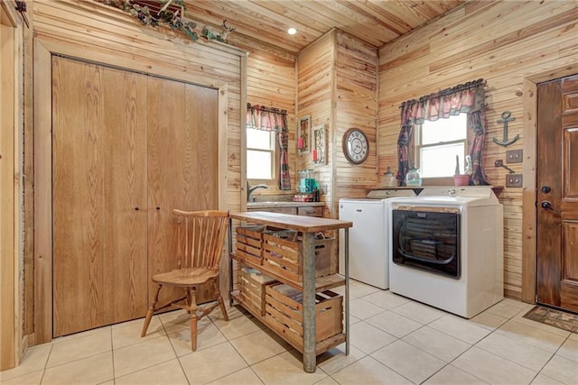 washroom featuring light tile patterned flooring, independent washer and dryer, wood ceiling, and wood walls