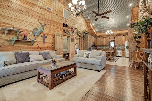 304 W Oak St, Canton, OK 73724 - living room with a chandelier, ceiling fan, wood ceiling, light wood-type flooring, and high vaulted ceiling