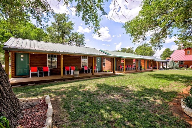 304 W Oak St, Canton, OK 73724 - back of property with a yard, a porch, and metal roof