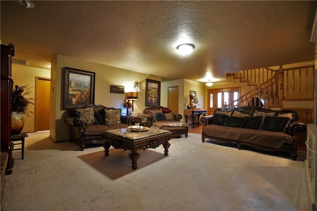 carpeted living room with a textured ceiling