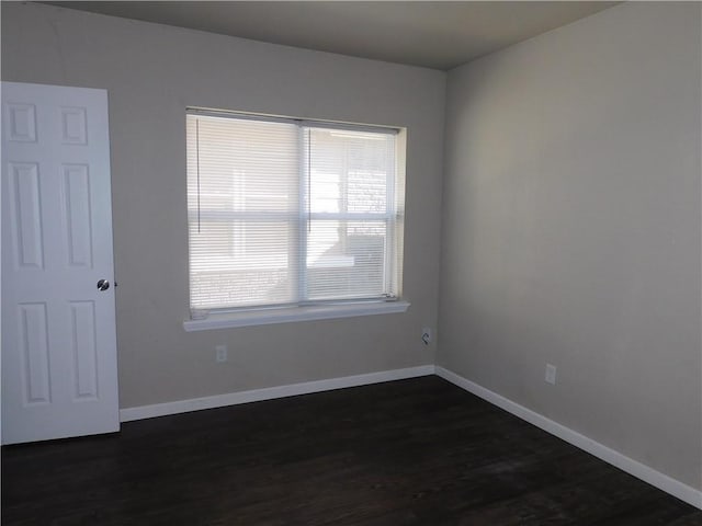 spare room with dark hardwood / wood-style flooring