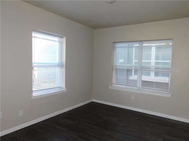 empty room featuring dark wood-type flooring