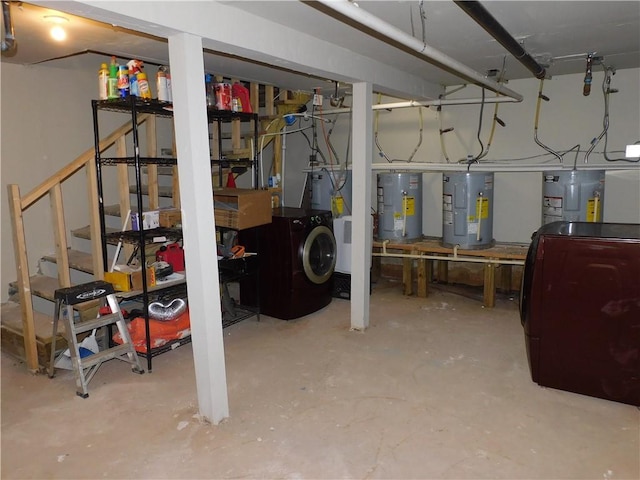 basement with electric water heater, washer / clothes dryer, and a workshop area