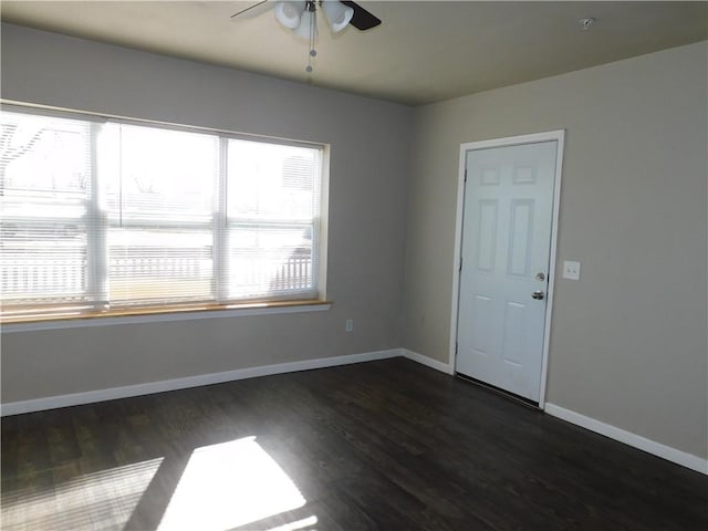 empty room featuring ceiling fan and dark wood-type flooring