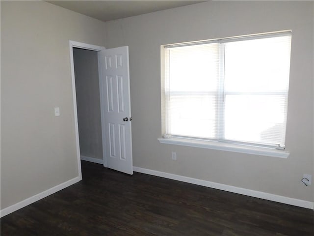 empty room with dark wood-type flooring