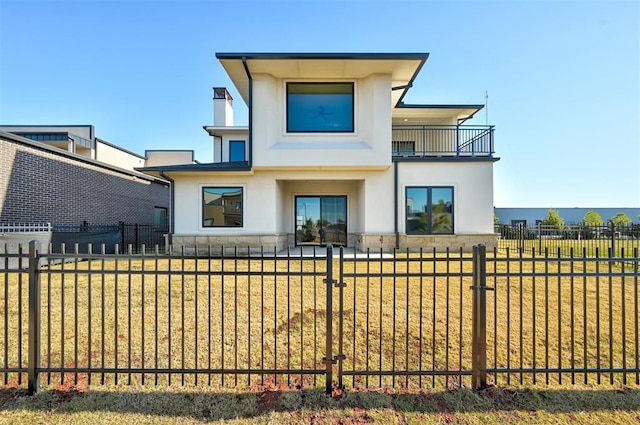 rear view of house featuring a balcony