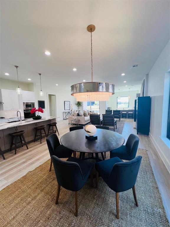 dining room featuring light wood-type flooring and sink