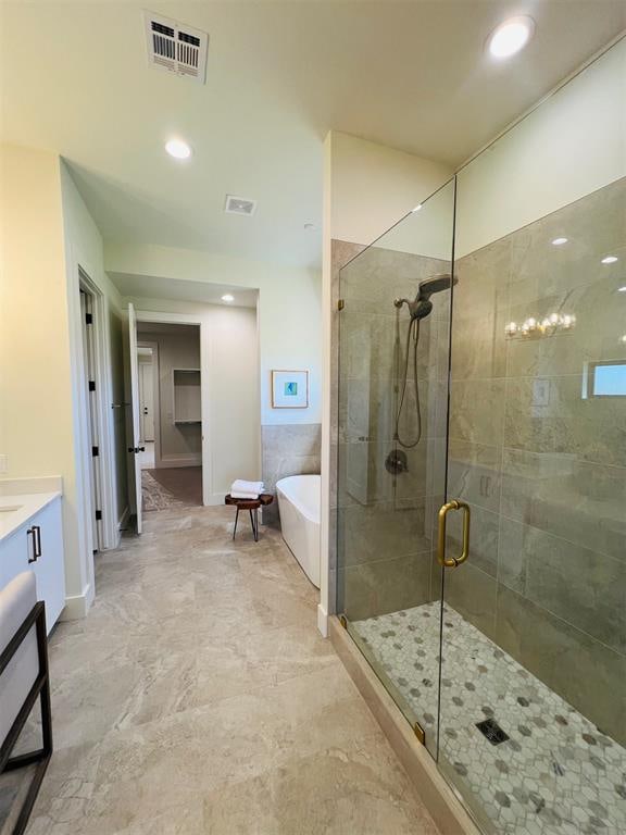 bathroom with separate shower and tub and vanity