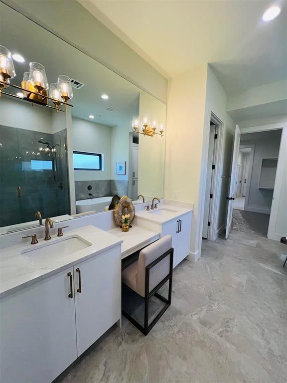 bathroom featuring vanity and shower with separate bathtub