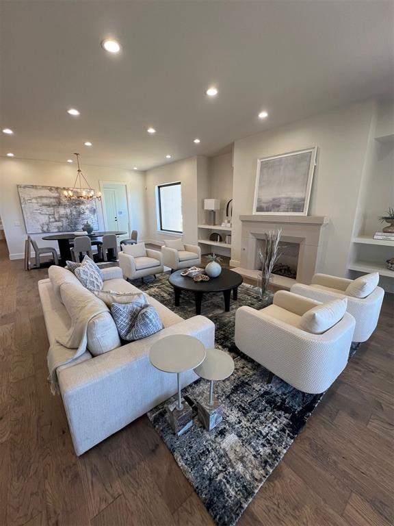 living room with dark hardwood / wood-style flooring and a notable chandelier