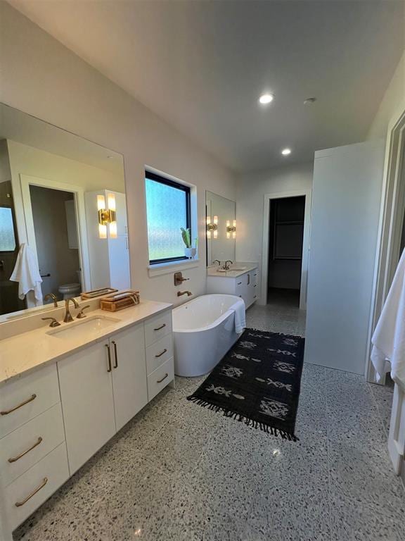 bathroom featuring vanity, toilet, and a bath