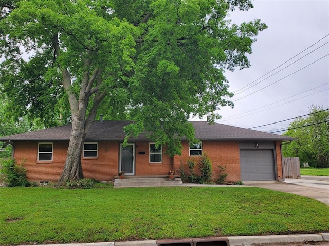 ranch-style house with an attached garage, a front lawn, brick siding, and driveway