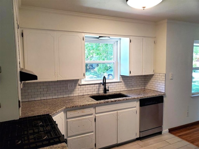 kitchen featuring a sink, light wood-type flooring, white cabinetry, stainless steel dishwasher, and decorative backsplash