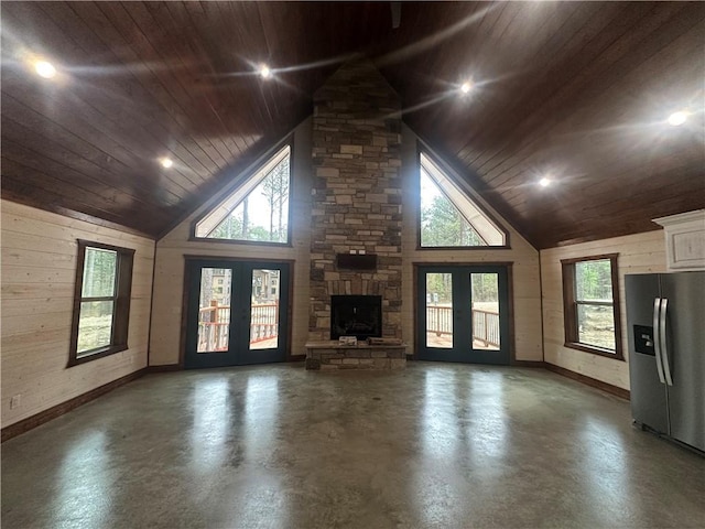 unfurnished living room featuring french doors, high vaulted ceiling, and wooden ceiling