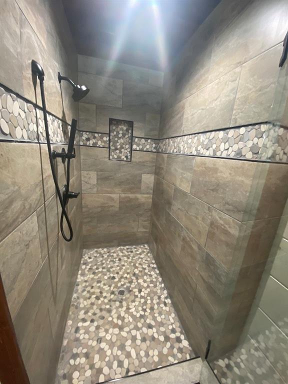 bathroom with a tile shower