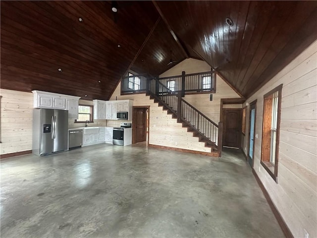 garage with stainless steel fridge with ice dispenser, sink, wood walls, and wood ceiling