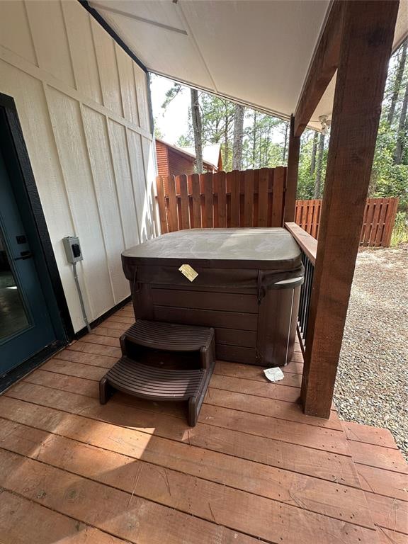 wooden deck with a hot tub