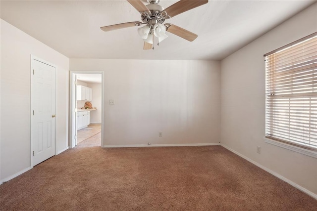 carpeted empty room with ceiling fan