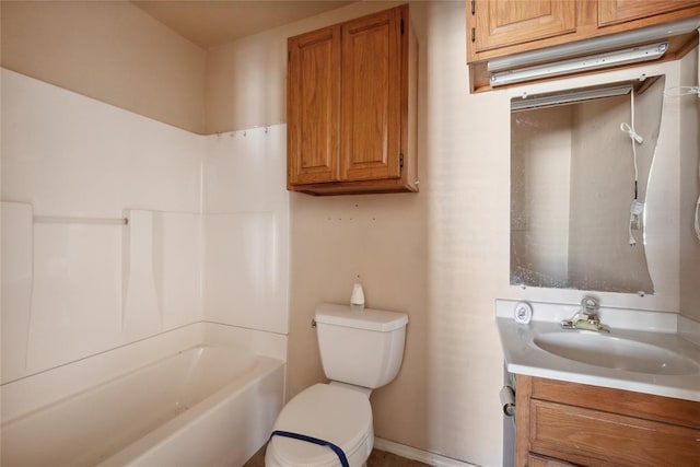 bathroom featuring vanity, toilet, and a tub