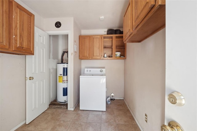 washroom featuring light tile patterned floors, cabinets, electric water heater, and washer / clothes dryer