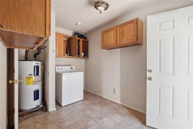 laundry room featuring cabinets, light tile patterned floors, electric water heater, and washer / clothes dryer