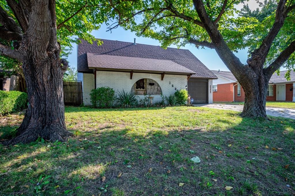 single story home with a front yard and a garage