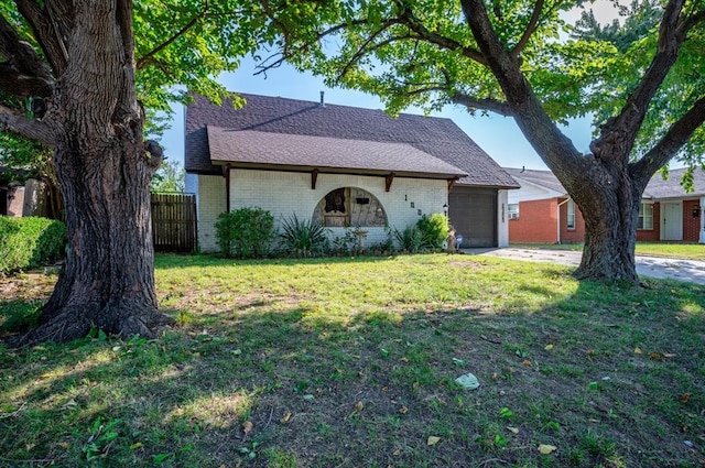 single story home with a front yard and a garage