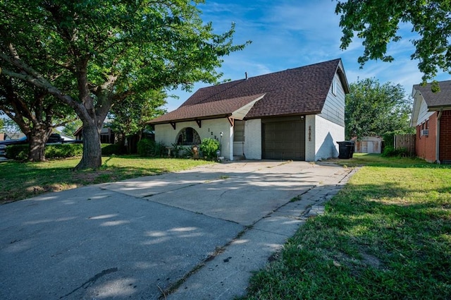 view of front of house with a garage and a front lawn