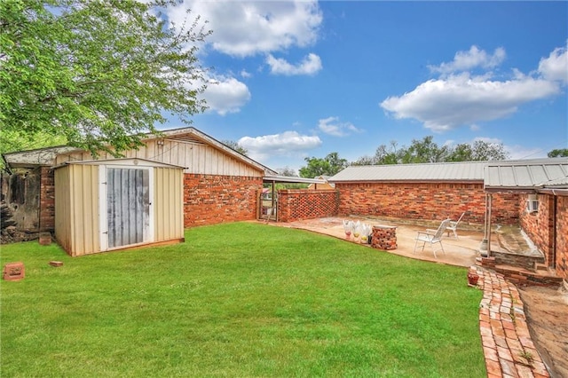 view of yard with a storage shed and a patio