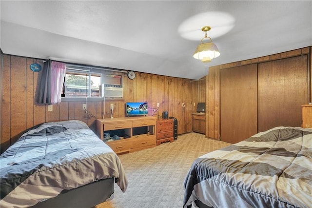 carpeted bedroom featuring wood walls, a closet, and vaulted ceiling