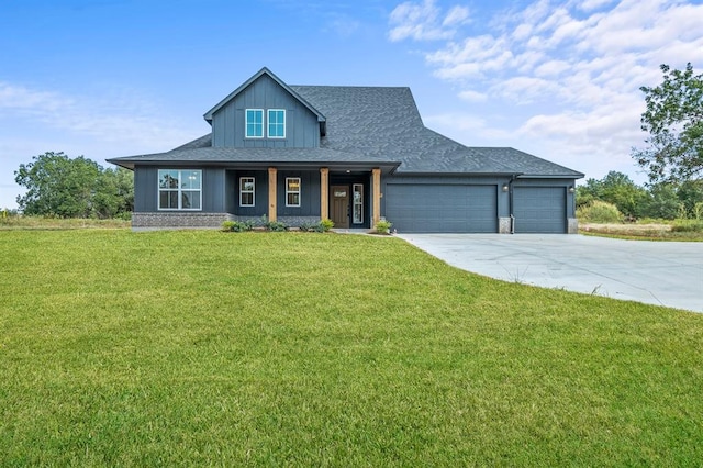 view of front of property featuring a front yard and a garage