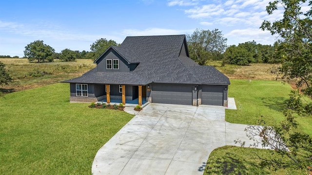 view of front of property featuring a garage, covered porch, and a front lawn