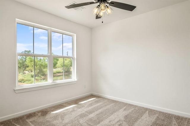 carpeted empty room with ceiling fan and a healthy amount of sunlight