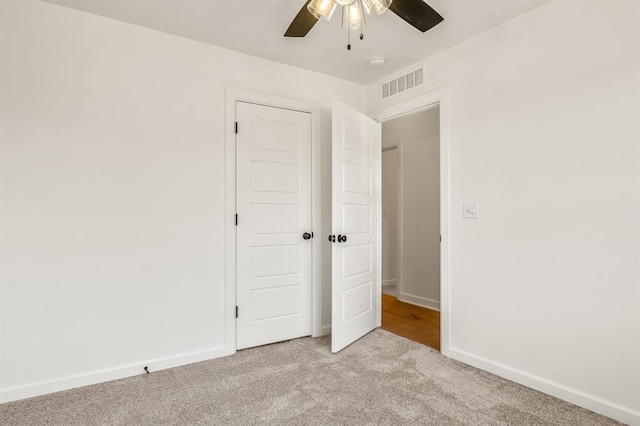 unfurnished bedroom featuring ceiling fan and light carpet