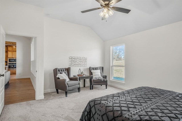 bedroom with ceiling fan, lofted ceiling, and carpet floors