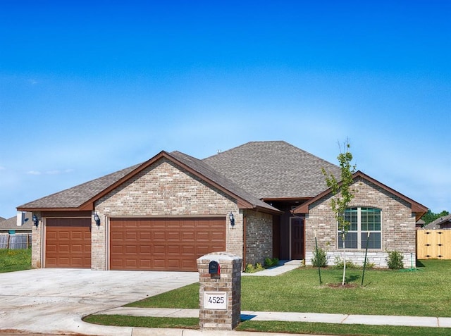 ranch-style house featuring a garage and a front lawn