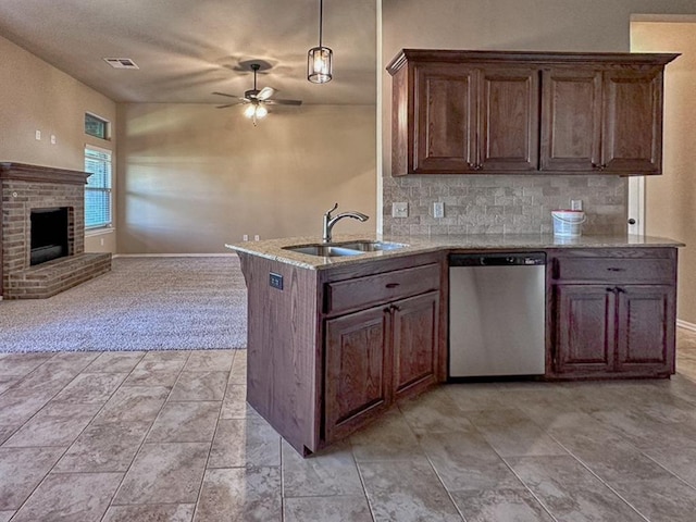 kitchen featuring ceiling fan, sink, tasteful backsplash, stainless steel dishwasher, and decorative light fixtures