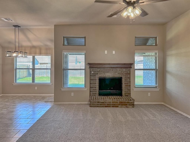 unfurnished living room featuring ceiling fan, carpet floors, and a brick fireplace