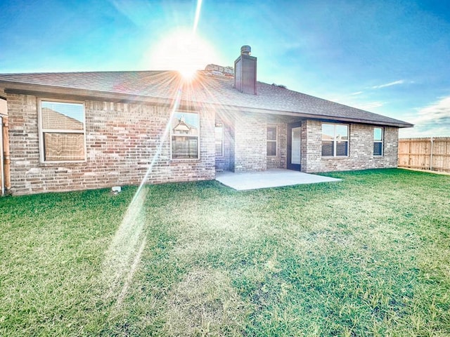 back of house featuring a yard and a patio area