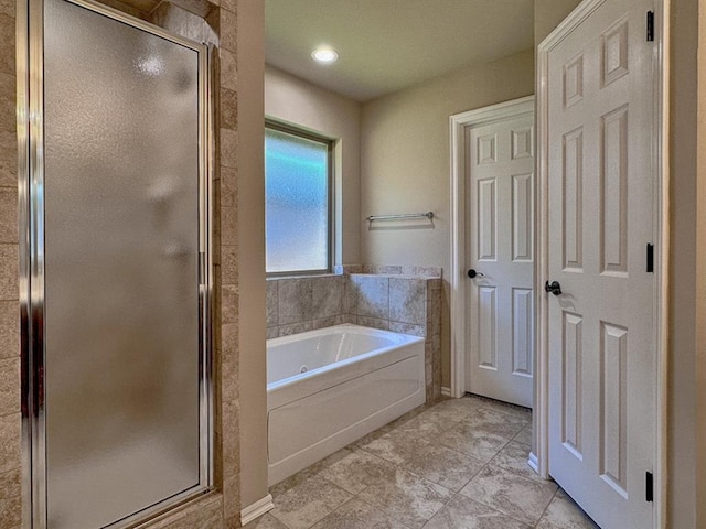 bathroom featuring tile patterned flooring and separate shower and tub