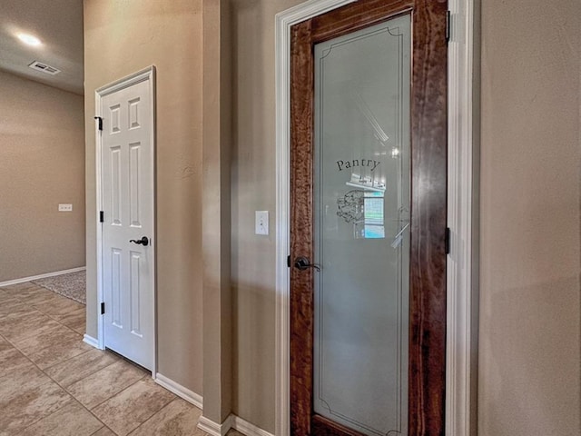 hallway with light tile patterned flooring