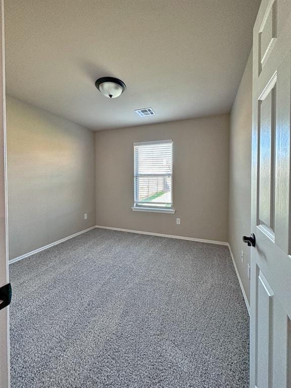 carpeted spare room with a textured ceiling