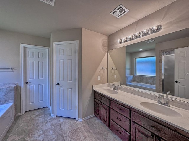 bathroom featuring vanity and a bath