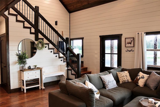 living room featuring plenty of natural light and wooden walls