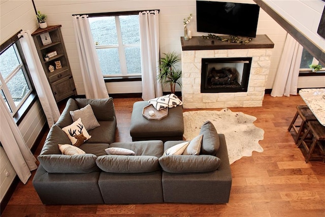 living room with wood walls and hardwood / wood-style flooring