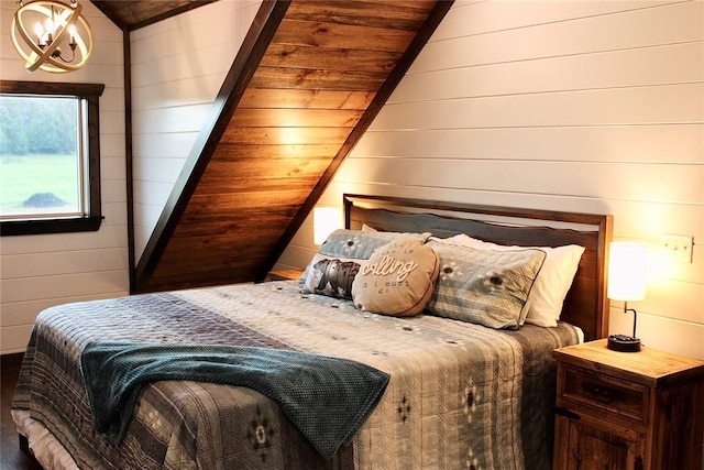 bedroom featuring wooden walls, wood ceiling, lofted ceiling, and an inviting chandelier